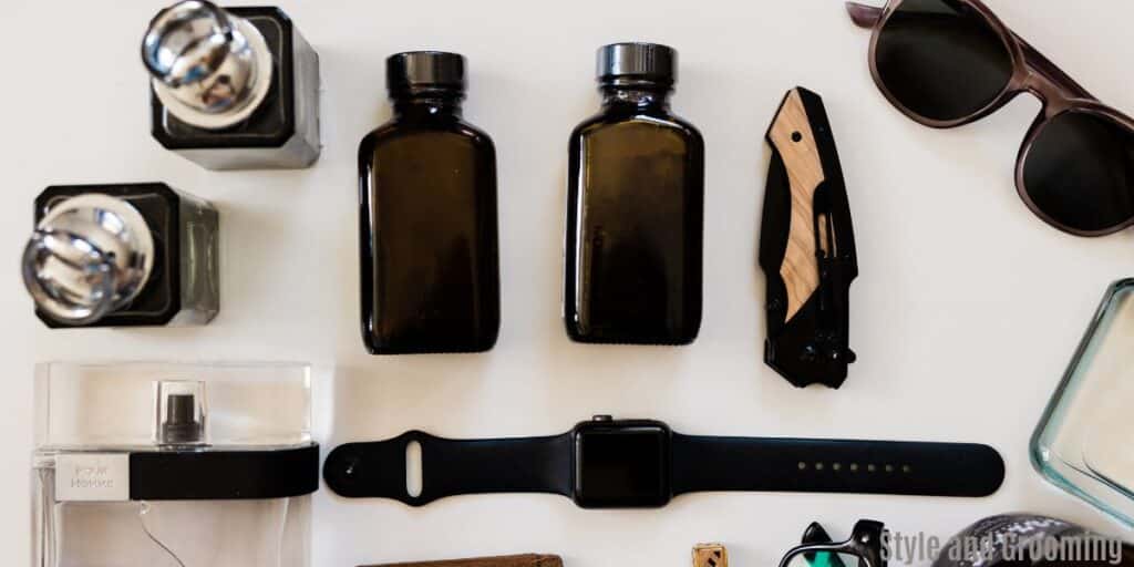 image wit perfumes, sunglasses, iwatch. Mostly man accessories. 
