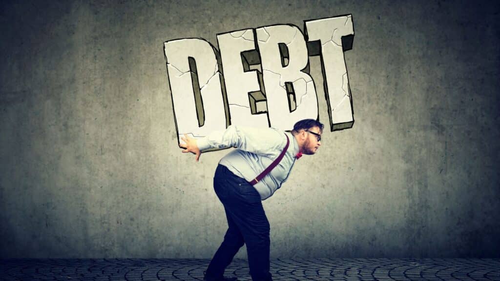 Avoid Accumulating More Debt. man carrying a debt big words on is back 