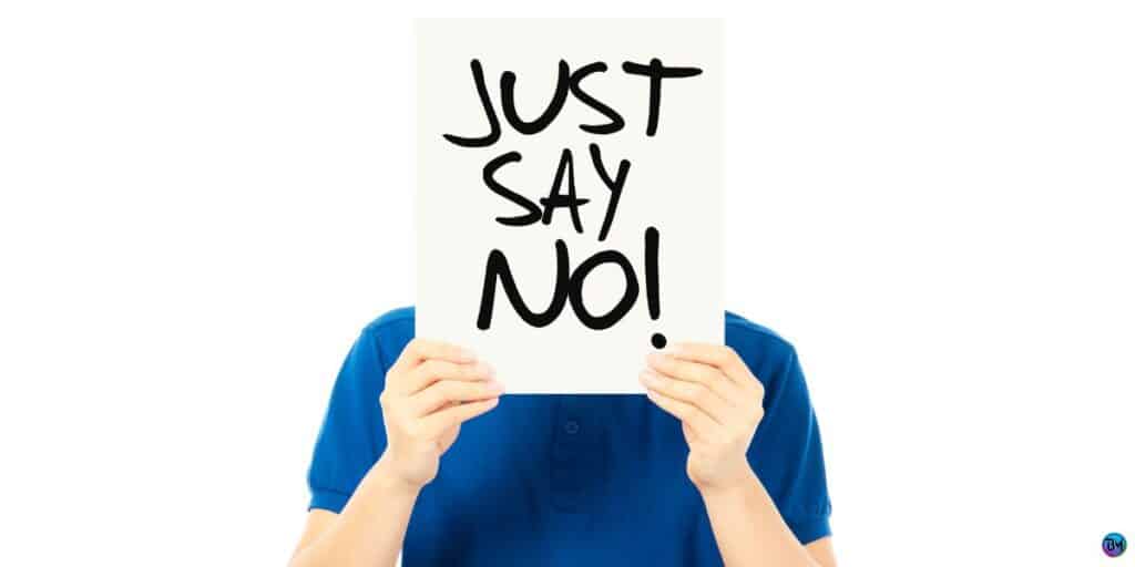 a person holding a sign that says just say no. 