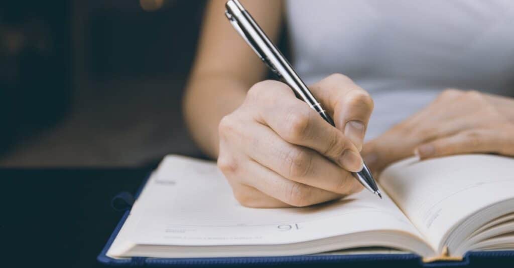 a person writing on a book